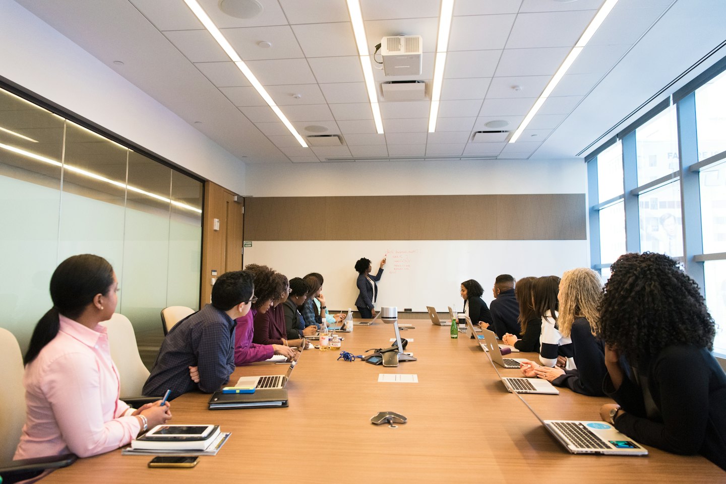 Diverse team collaborating around a conference table during a meeting.